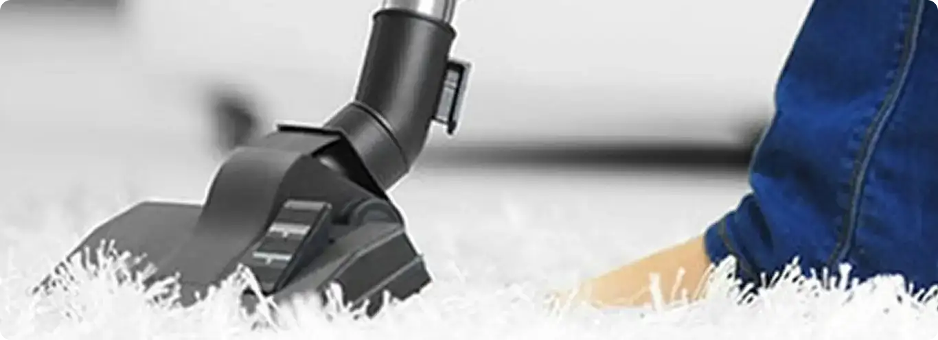 Close-up of a professional vacuuming a white carpet in Rio Rancho.